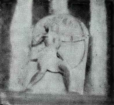 A relief of a man drawing a large bow, carved on a slab between two pillars.